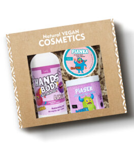 LaQ children's cosmetics set containing a shower gel in a 300 ml pump bottle, a pink bubblegum-scented shower foam in a jar, and a pink fizzy bath sand in a jar, packed in a gift box on hay